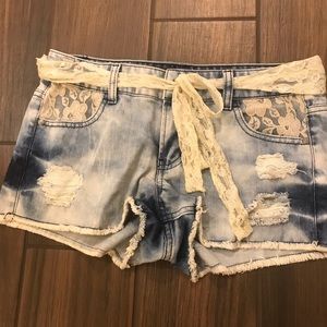 Light wash denim shorts with lace detail